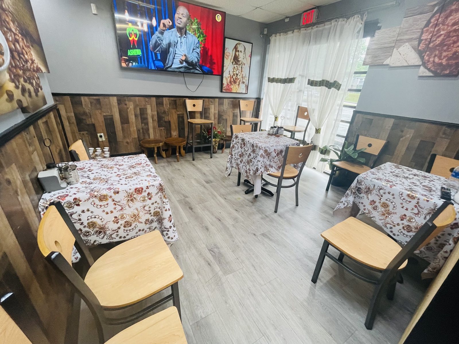 Eyoha's dining room with floral tablecloths and Ethiopian wall art
