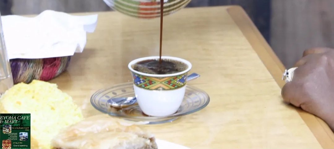 Coffee being poured from a jebena into a cup